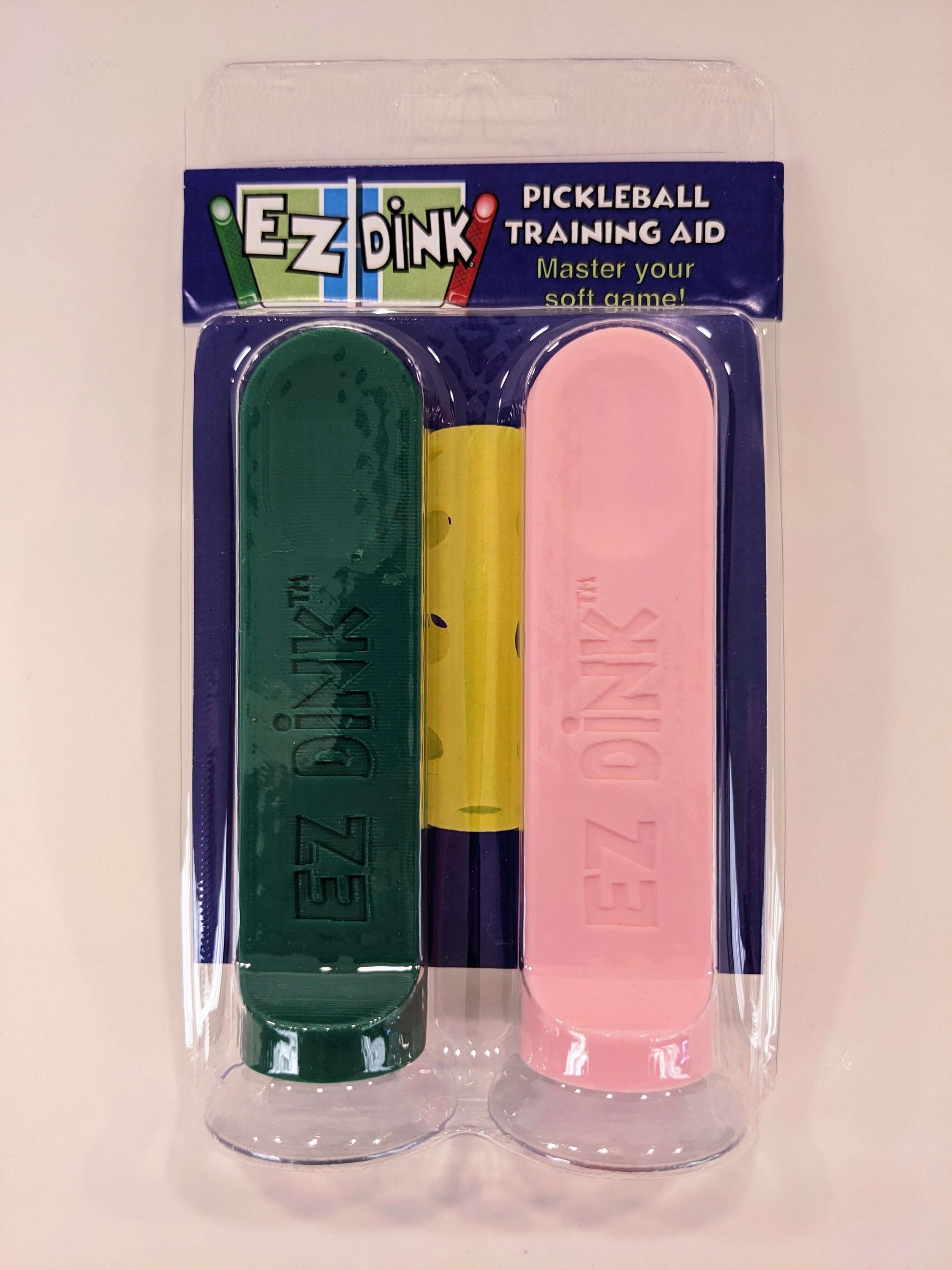 A twin pack of EZ Dink pickleball dinking training aid in Green and pink