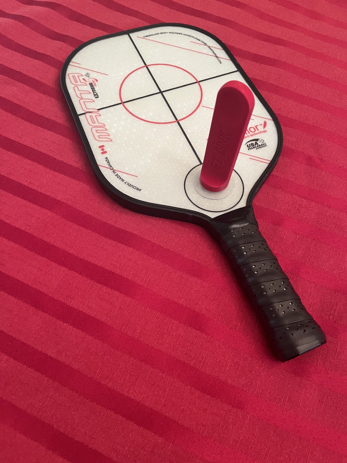Pickleball paddle on a red background